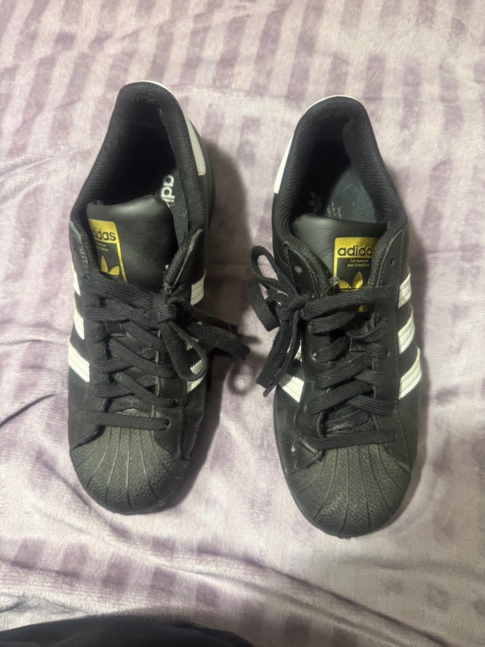 Adidas Black Sneakers with White Stripes and Gold Tongue Logo